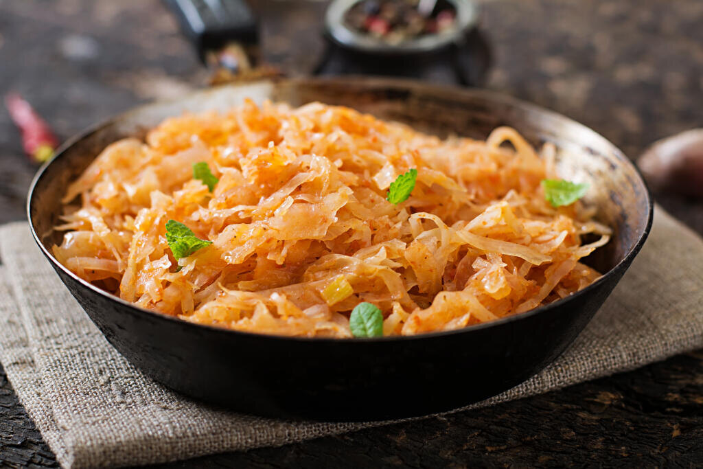 Stewed cabbage on the old wooden background in rustic style Журналист