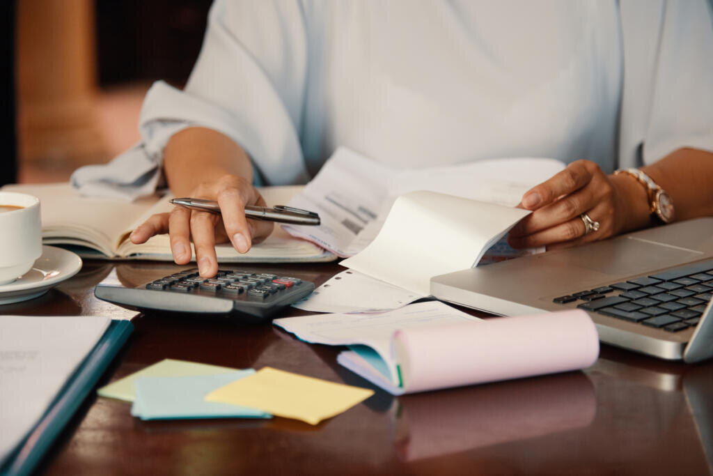 Hands of female entrepreneur working with bills and documents Журналист
