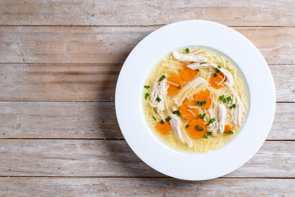 Homemade chicken soup on wooden table Журналист