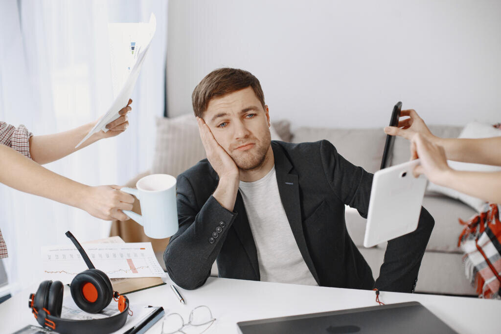 Man sitting in living room at home. Sad man tired from work. Журналист