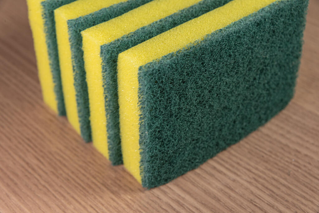 Kitchen sponge on the wooden background Журналист